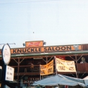 The Knuckle Saloon is home to KNKL-AM, the voice of the downtown during the Sturgis Rally. Two Technomad loudspeakers sit atop the building, unprotected from the elements.,