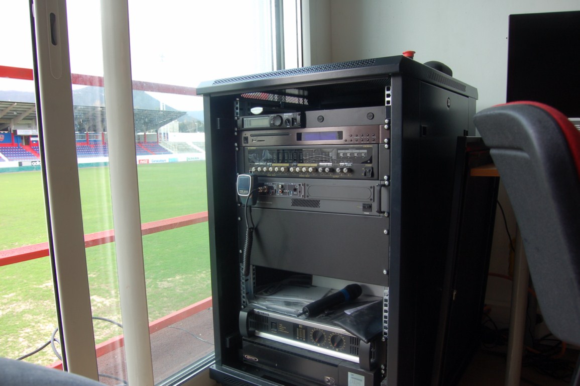 The complete system includes amplifiers and mixers, a wireless microphone, and an automated playout system for security announcements