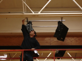 Alex DeMartino at Syracuse Time & Alarm hangs Nohos in the South Lewis middle school gym